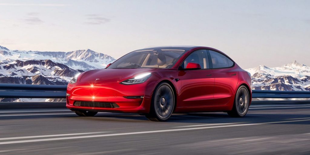 Red Tesla Model 3 in the mountains- best selling electric car of 2021