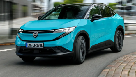 Nissan Leaf crossover electric car driving on a road, showing modern SUV design
